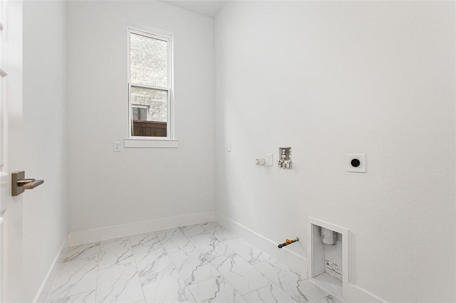 Laundry room featuring gas dryer hookup, hookup for a washing machine, and hookup for an electric dryer