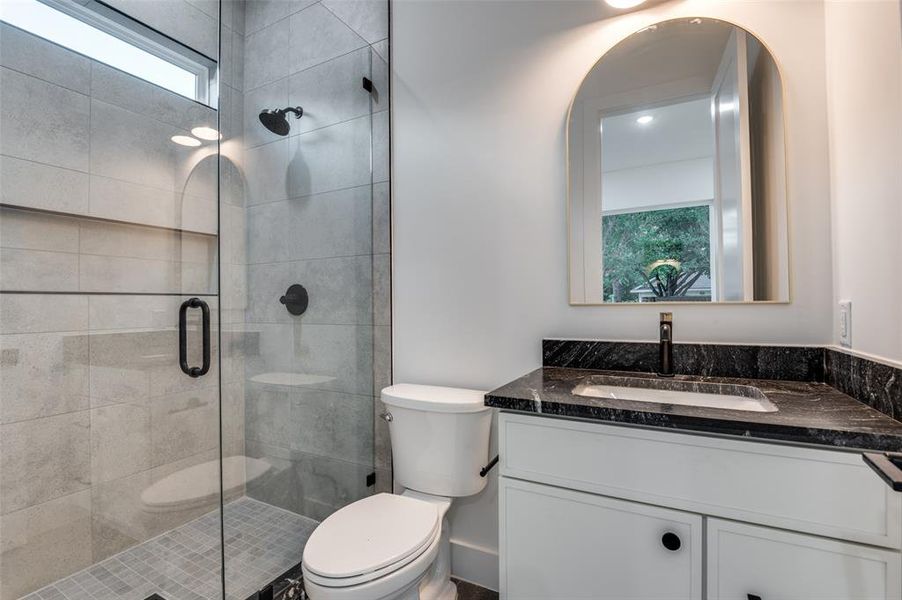 Bathroom with vanity and a shower stall Bathroom with vanity and a shower stall
