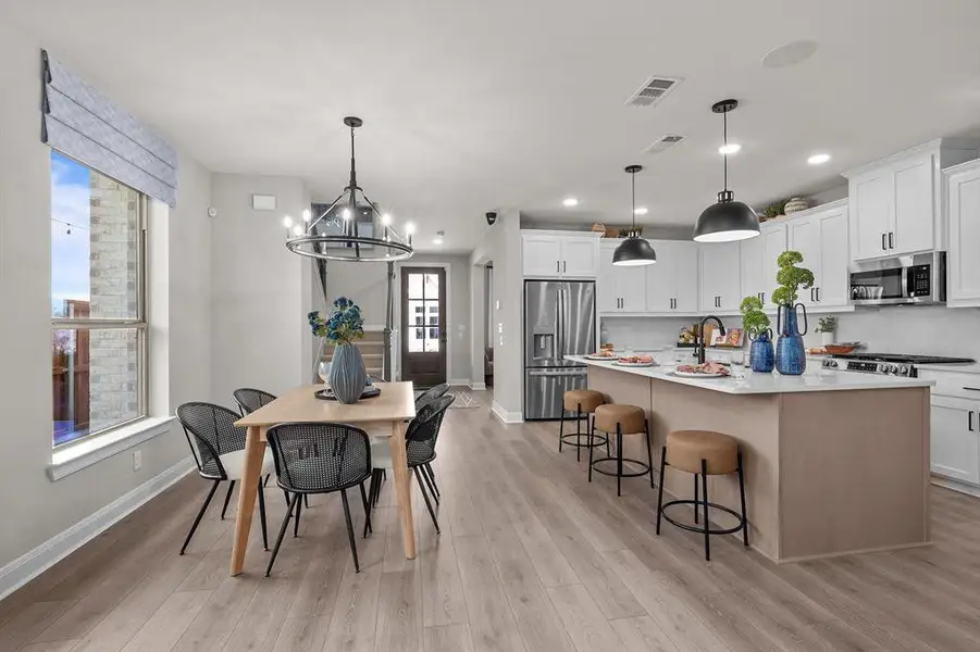 Dining area with a chandelier and light wood-style flooring