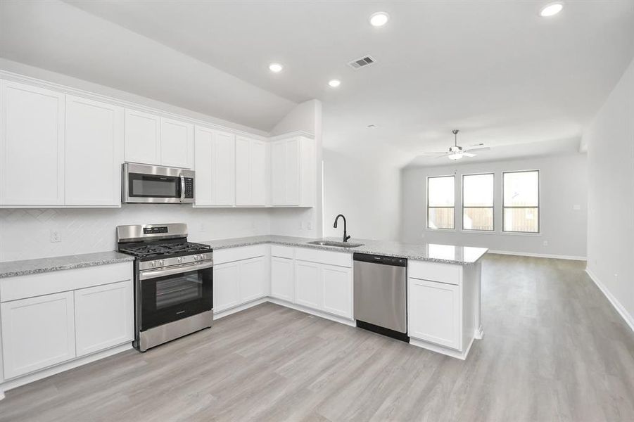 The open concept effortlessly connects the kitchen to the expansive family room, forming a perfect hub for gatherings. This seamless flow creates an inviting space where cooking and socializing come together harmoniously.