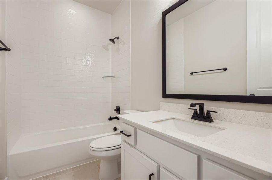 Full bath featuring vanity, shower / bathtub combination, and light tile patterned floors