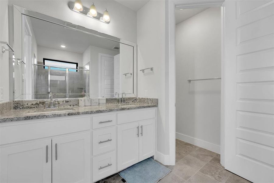 Bathroom featuring vanity and an enclosed shower