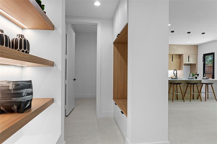 Hall with sink and light tile patterned flooring