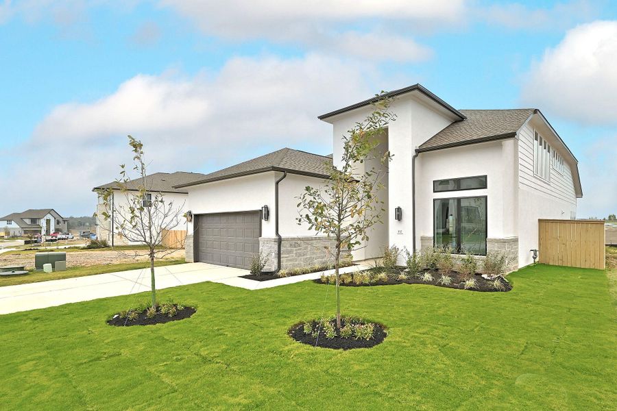 Front exterior of a new home in The Colony, Bastrop, TX, highlighting curb appeal (Image 24).