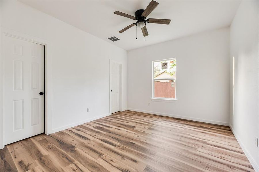 Unfurnished bedroom featuring light wood-type flooring and a ceiling fan