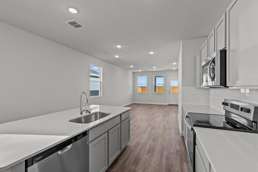 A kitchen with white cabinets.