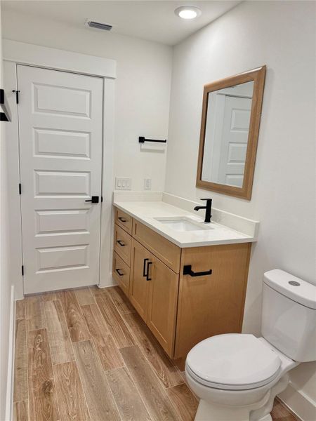 Bathroom with light wood finished floors and vanity