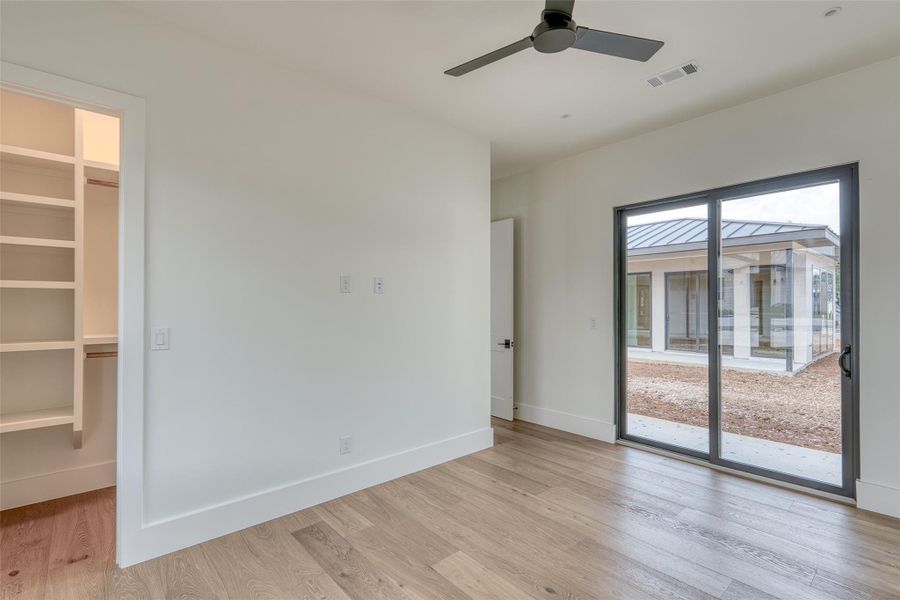 Secondary bedroom looking out to courtyard (possible future pool area)
