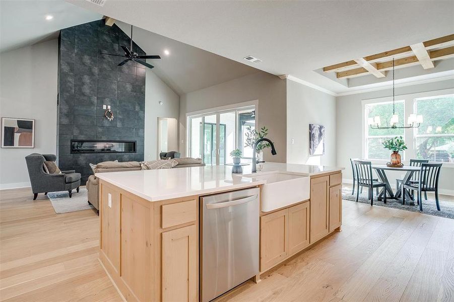 Kitchen featuring dishwasher, visible vents, light brown cabinetry, and a sink Kitchen featuring dishwasher, visible vents, light brown cabinetry, and a sink
