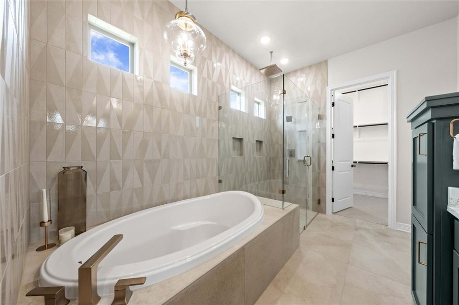 Indulge in a tranquil retreat featuring a spacious soaking tub and a walk-in shower, offering a serene escape. Indulge in a tranquil retreat featuring a spacious soaking tub and a walk-in shower, offering a serene escape.