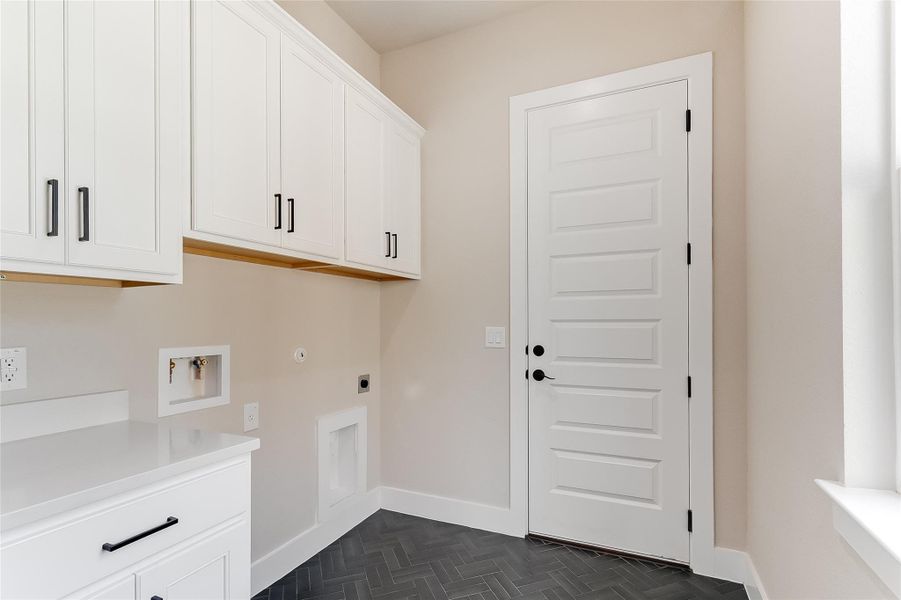 Washroom featuring washer hookup, cabinet space, electric dryer hookup, and gas dryer hookup Washroom featuring washer hookup, cabinet space, electric dryer hookup, and gas dryer hookup