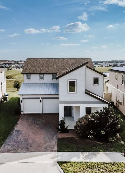 Front exterior of a new home in , Winter Garden, FL, highlighting curb appeal (Image 1).