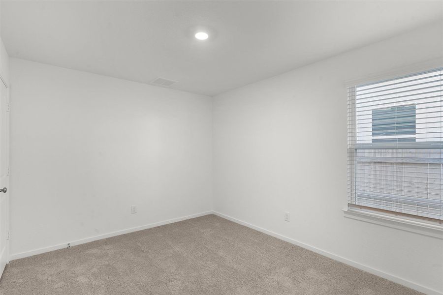 Carpeted spare room with baseboards
