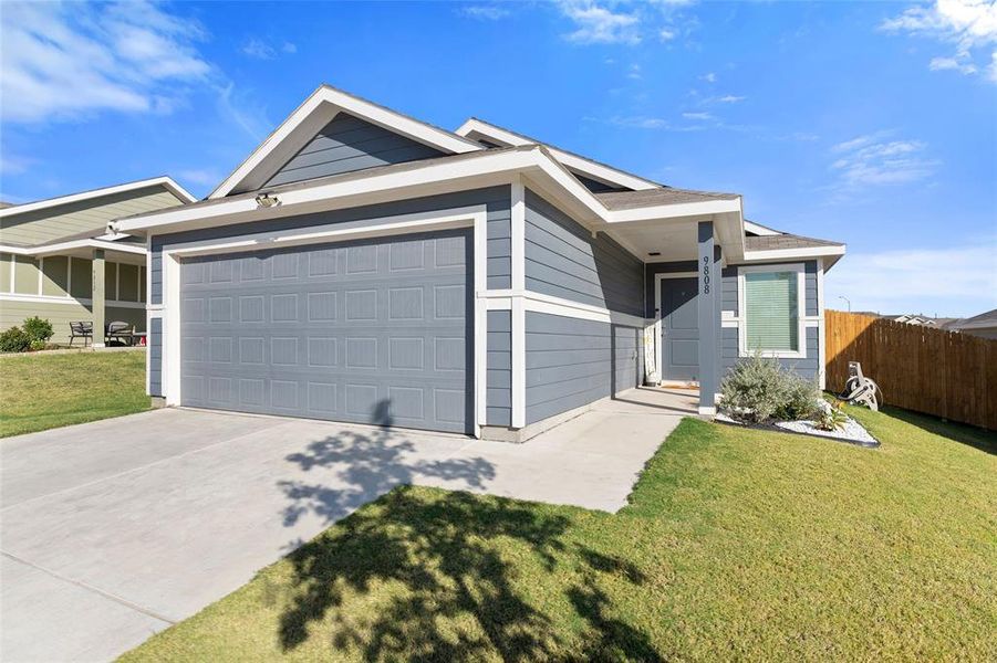 Ranch-style home with driveway and an attached garage