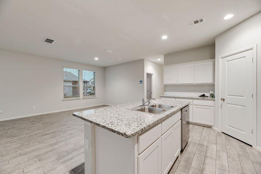 Kitchen island with granite countertop and double stainless steel sink