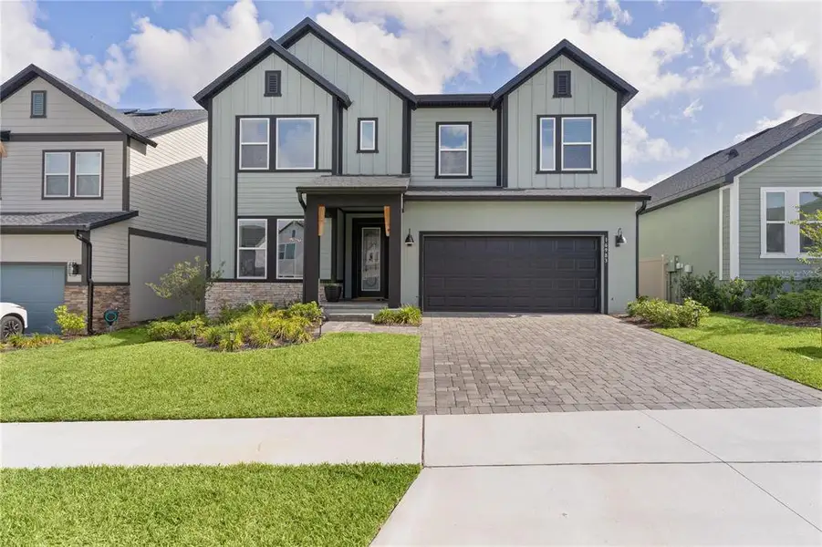 Front exterior of a new home in , Clermont, FL, highlighting curb appeal (Image 23).