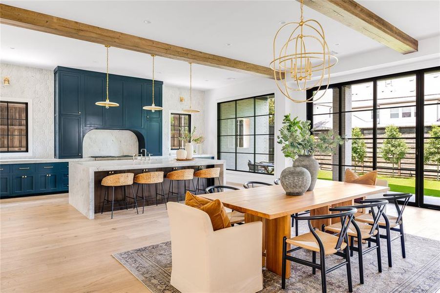 Dining space featuring a notable chandelier, beam ceiling, and light hardwood / wood-style floors