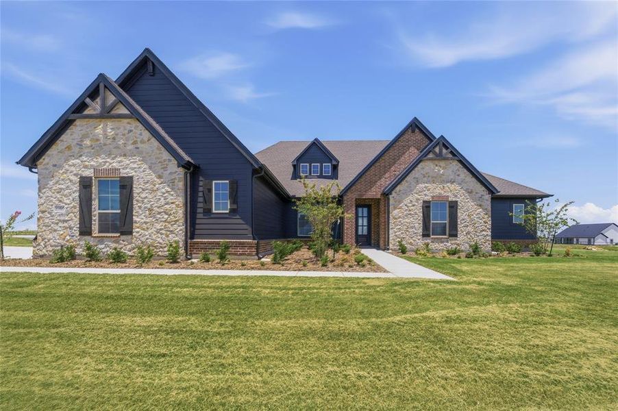 Stone and siding exterior featuring dark trim, a covered entry, and dormer windows Stone and siding exterior featuring dark trim, a covered entry, and dormer windows