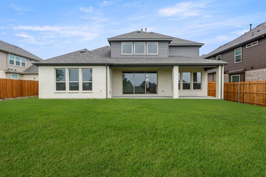 Front exterior of a new home in Woodcreek, Fate, TX, highlighting curb appeal (Image 20). Front exterior of a new home in Woodcreek, Fate, TX, highlighting curb appeal (Image 20).