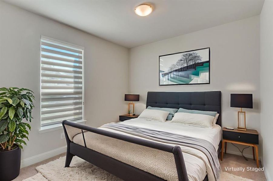 Carpeted bedroom featuring baseboards Carpeted bedroom featuring baseboards