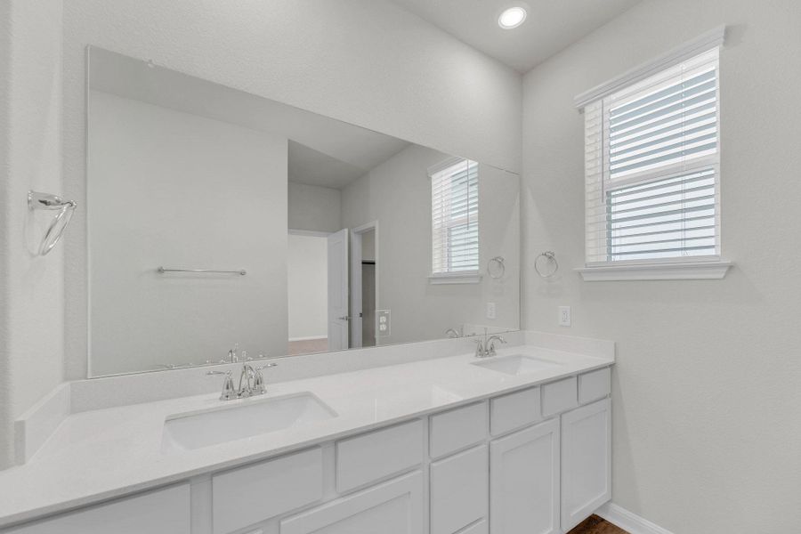 Full bath featuring double vanity and recessed lighting