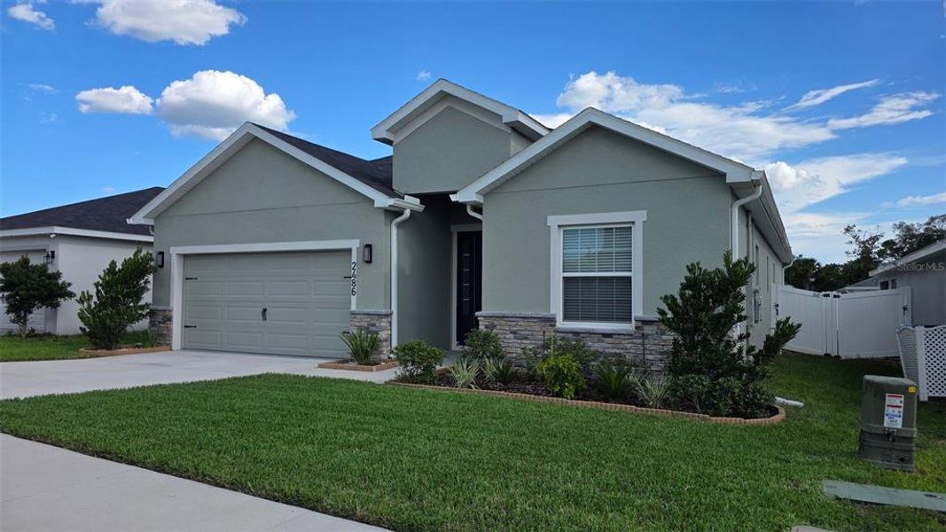 Front exterior of a new home in Geneva Landings, Davenport, FL, highlighting curb appeal (Image 1). Front exterior of a new home in Geneva Landings, Davenport, FL, highlighting curb appeal (Image 1).