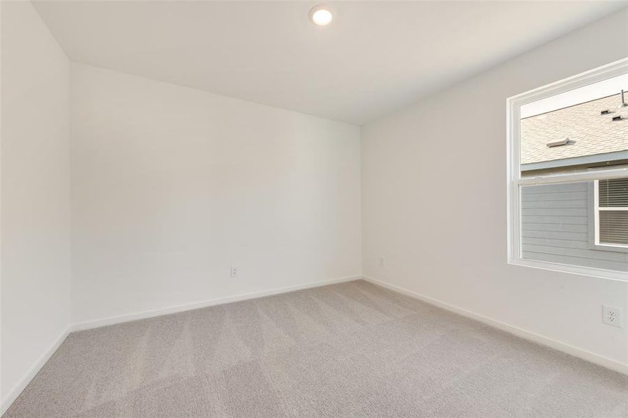 Carpeted empty room featuring baseboards and recessed lighting