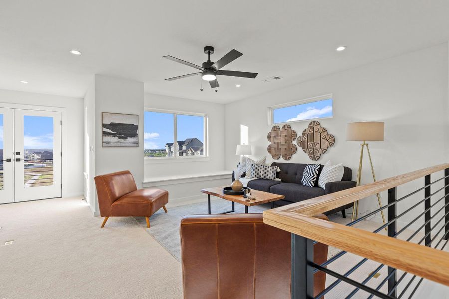 Carpeted living area featuring a ceiling fan, french doors, and recessed lighting