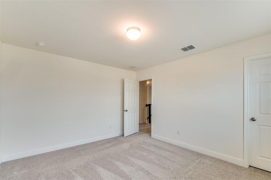 Unfurnished room featuring light colored carpet and baseboards
