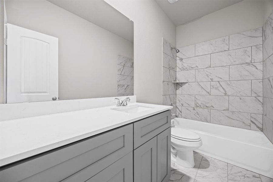 Clean lines and elegant marble-patterned tile define this modern bathroom space. Clean lines and elegant marble-patterned tile define this modern bathroom space.