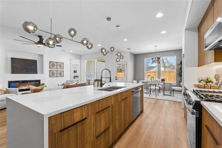 Kitchen featuring brown cabinets, modern cabinets, light wood-style flooring, and recessed lighting Kitchen featuring brown cabinets, modern cabinets, light wood-style flooring, and recessed lighting