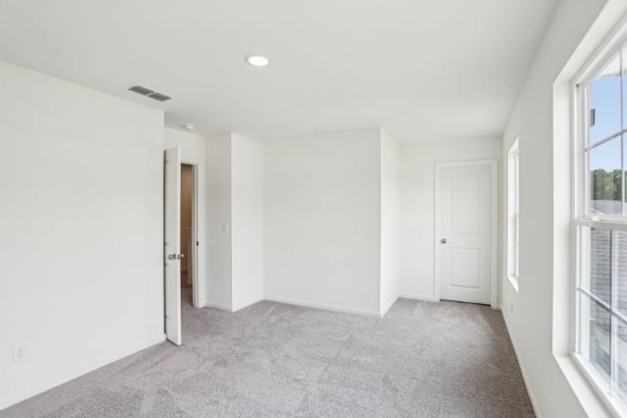 A hallway with white doors.