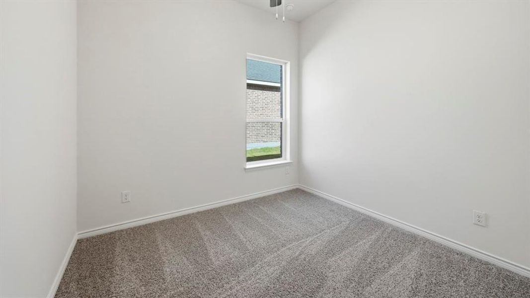 Carpeted room featuring a single window, white walls, and a ceiling fan