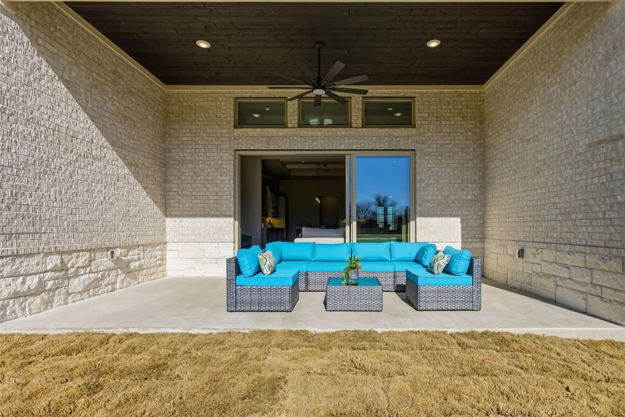 View of patio with ceiling fan and outdoor seating