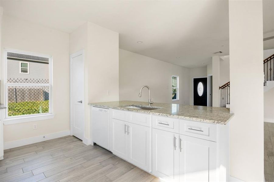 Any chef's dream, this stunning kitchen is perfect for everyday life as well as entertaining family and friends! Extra large breakfast bar is perfect for conversation or that much needed space to lay out your party spread for everyone to enjoy! Large windows provide lovely views of your backyard and plenty of natural lighting throughout the day.