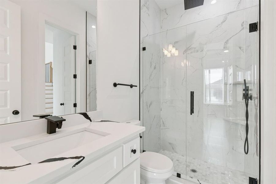 Bathroom with a marble finish shower and vanity Bathroom with a marble finish shower and vanity