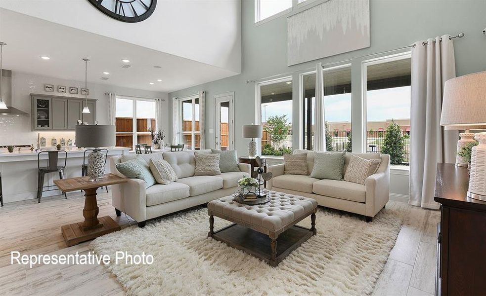 Open-concept living space with high ceilings and wood-finish flooring