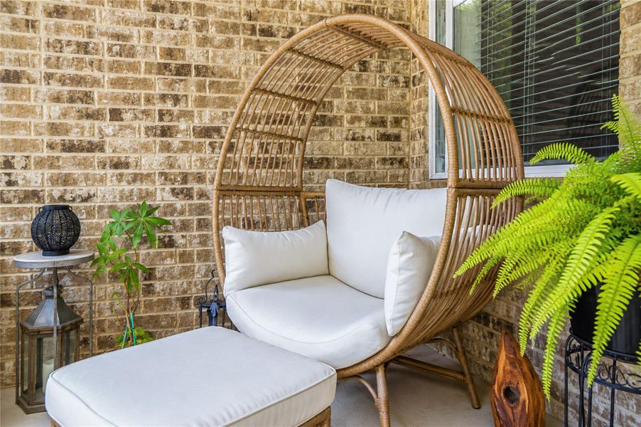 A cozy outdoor retreat tucked beneath the covered patio, ideal for quiet moments outdoors. A cozy outdoor retreat tucked beneath the covered patio, ideal for quiet moments outdoors.