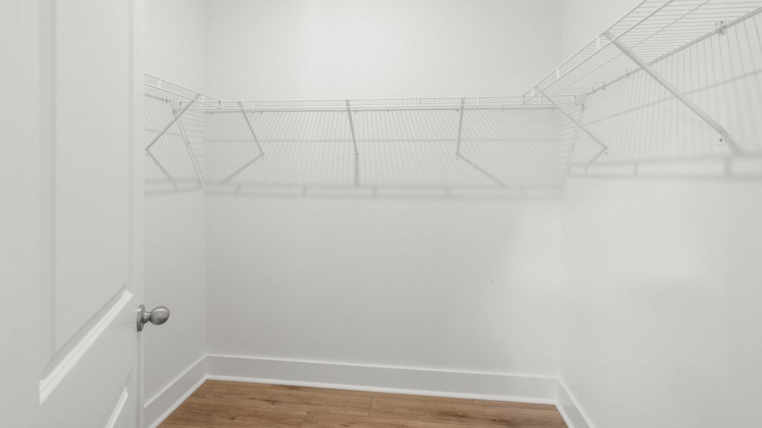 Spacious walk-in closet with built-in shelving for organized, everyday living. Spacious walk-in closet with built-in shelving for organized, everyday living.