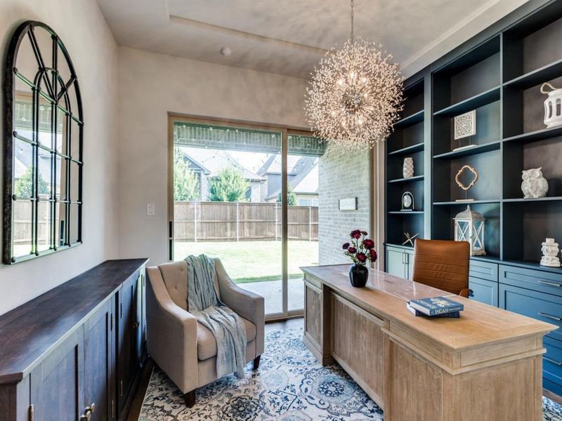 Office area featuring a chandelier, healthy amount of natural light, and built in features