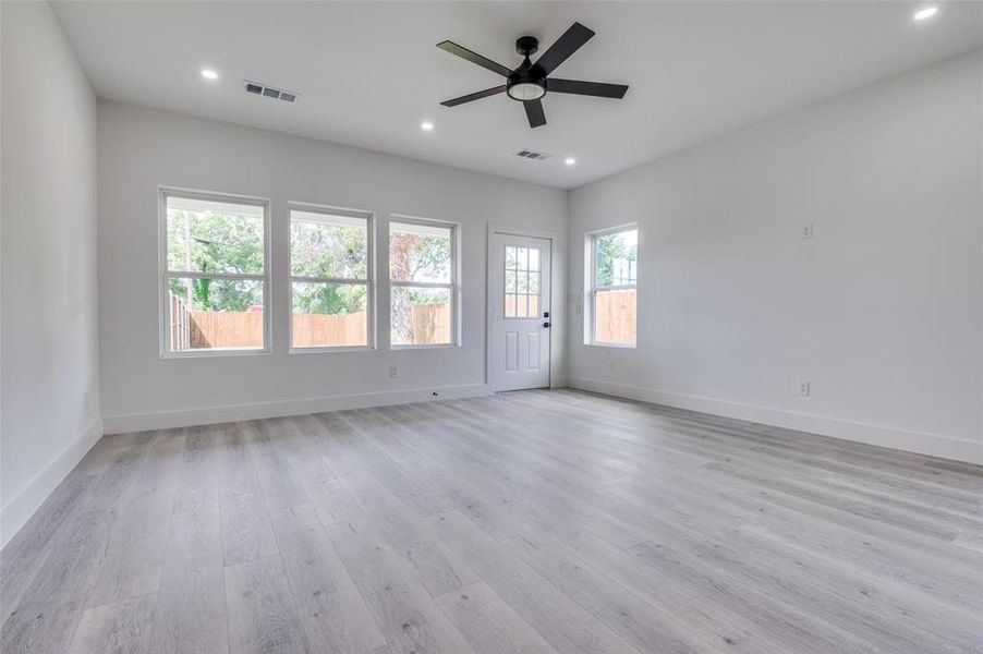 Spare room featuring light wood-style floors, ceiling fan, and recessed lighting Spare room featuring light wood-style floors, ceiling fan, and recessed lighting