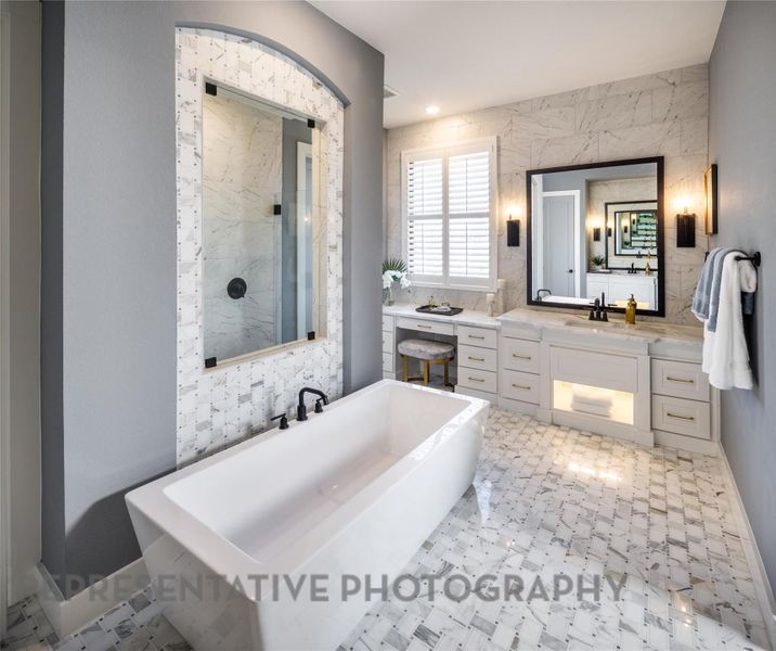 Bathroom featuring a freestanding tub, vanity, and a tile shower