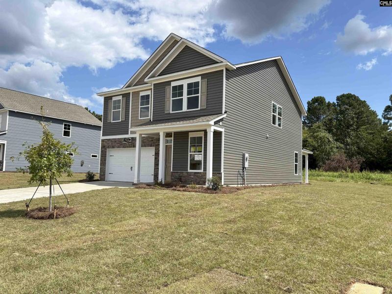 Front exterior of a new home in Rolling Hills, Prosperity, SC, highlighting curb appeal (Image 2).