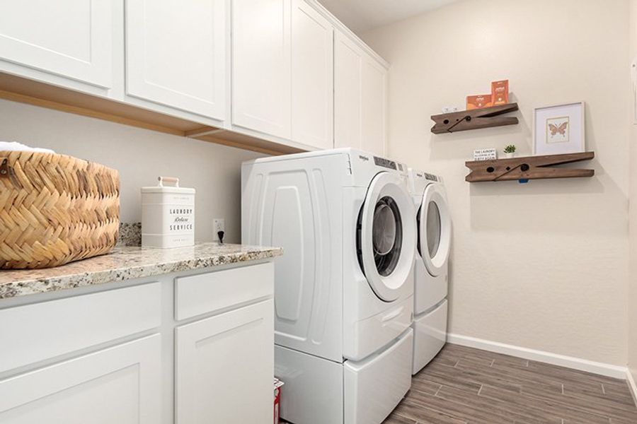 A washing machine in a kitchen. A washing machine in a kitchen.