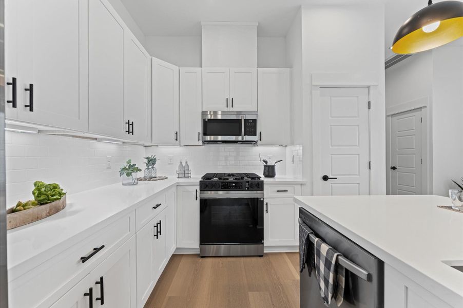 This stylish kitchen showcases plenty of sleek cabinetry, thoughtfully arranged to maximize storage and enhance the room’s modern aesthetic. Upper and lower cabinets feature clean lines and minimalist hardware, blending seamlessly with the space’s design. Integrated appliances and under-cabinet lighting add both function and flair, while the layout easy access and efficient organization. Ideal for culinary enthusiasts and entertainers alike, this kitchen combines smart storage with sophisticated style. This stylish kitchen showcases plenty of sleek cabinetry, thoughtfully arranged to maximize storage and enhance the room’s modern aesthetic. Upper and lower cabinets feature clean lines and minimalist hardware, blending seamlessly with the space’s design. Integrated appliances and under-cabinet lighting add both function and flair, while the layout easy access and efficient organization. Ideal for culinary enthusiasts and entertainers alike, this kitchen combines smart storage with sophisticated style.
