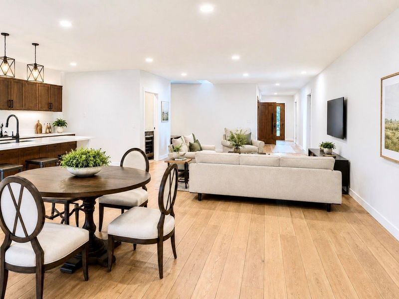 The planned open-concept kitchen, dining, and living area at 6671 Nielan St is designed with a bright, modern layout that connects the main living spaces. * Photo rendering shown as home is currently under construction | Final appearance may vary * The planned open-concept kitchen, dining, and living area at 6671 Nielan St is designed with a bright, modern layout that connects the main living spaces. * Photo rendering shown as home is currently under construction | Final appearance may vary *