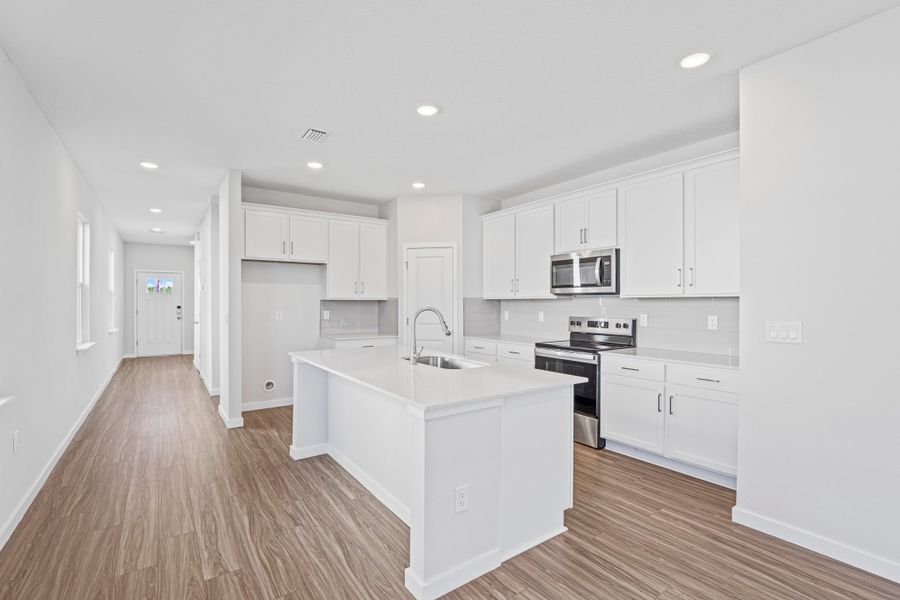 Lot 21 Kitchen with Large Island and White Cabinets at Camden Woods in Kingsland