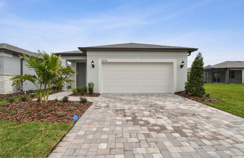 Representative exterior photo of a completed home built from the Hallmark by DiVosta in Costa Pointe, Vero Beach, FL (Image 21).