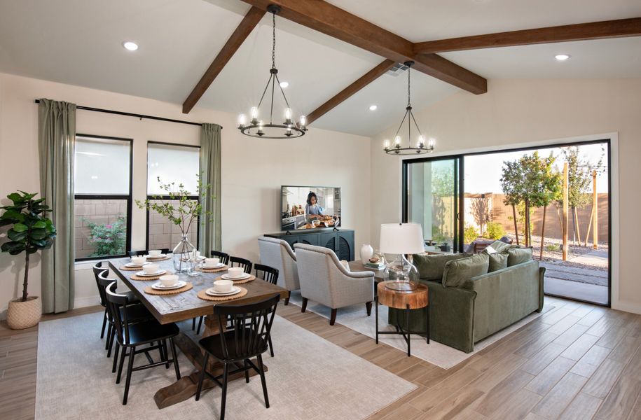 Dining area and great room with stained ceiling beams