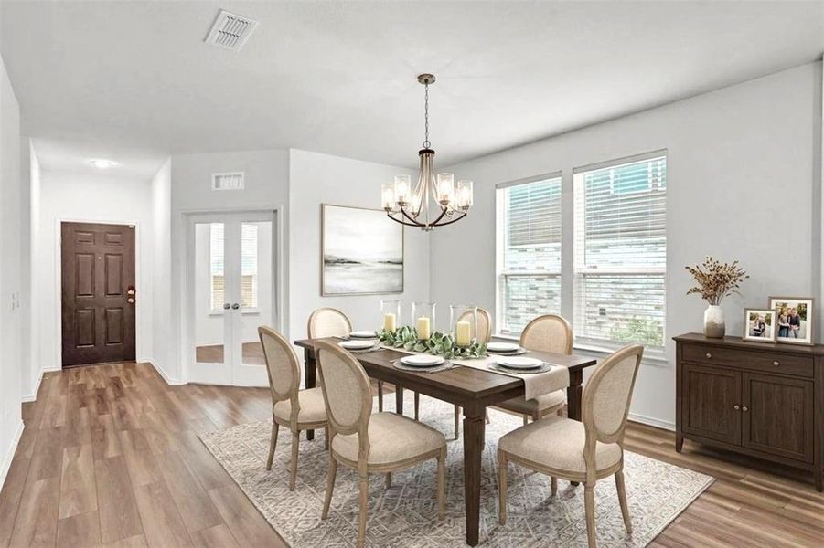 Spacious dining area featuring wood-finish flooring, a contemporary chandelier, two large windows with blinds, and white painted walls